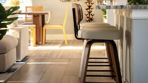 A modern kitchen with a wooden bar stool, a dining area with a wooden table and chairs, and a large window with natural light. - Charming 3-bedroom villa with AC, WiFi in tranquil Naples (Naples)
