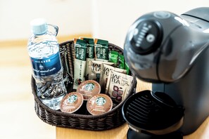 Enjoy a selection of specialty coffee pods and a reusable water bottle, along with a coffee maker for hot beverages.