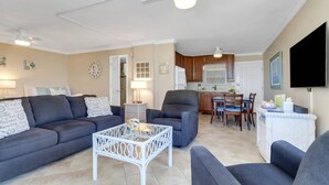 A living room with a sofa, armchairs, a coffee table, and a dining area with a table and chairs. - GULF VIEW | 2 QUEEN BEDS | SLEEPS 4 | 5TH FLOOR BALCONY | STEPS TO BONITA BEACH (Bonita Springs)