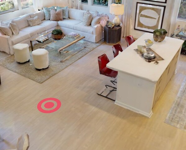 Relax in this stylish living room with a sofa set, coffee table, and a cozy reading chair.
