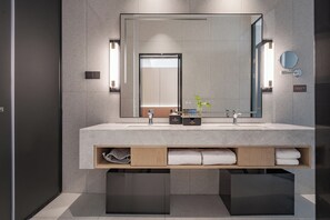 A modern bathroom with a large mirror, two sinks, and built-in storage. - Wanzai Yijia La Maison Hotel (Yichun)