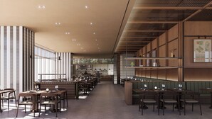 Un interior de restaurante moderno con techos altos, paredes a rayas y una barra larga.