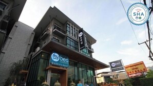 A modern hotel with a prominent 'my bed' sign, a contact number, and a SHA accreditation badge. - Mybed Chonburi (Chonburi)