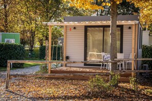 A small, single-story house with a covered porch and a sliding glass door.