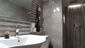 A modern bathroom with a large sink, a mirror, and a shower area. - Athens Smart 3-room Private Apartment (Athens)