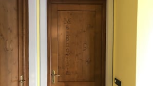 A wooden door with the number 9 and the name "Margherita" carved into it. - 012 Trilocale a due Passi Dagli Impianti Pinzolo (Carisolo)