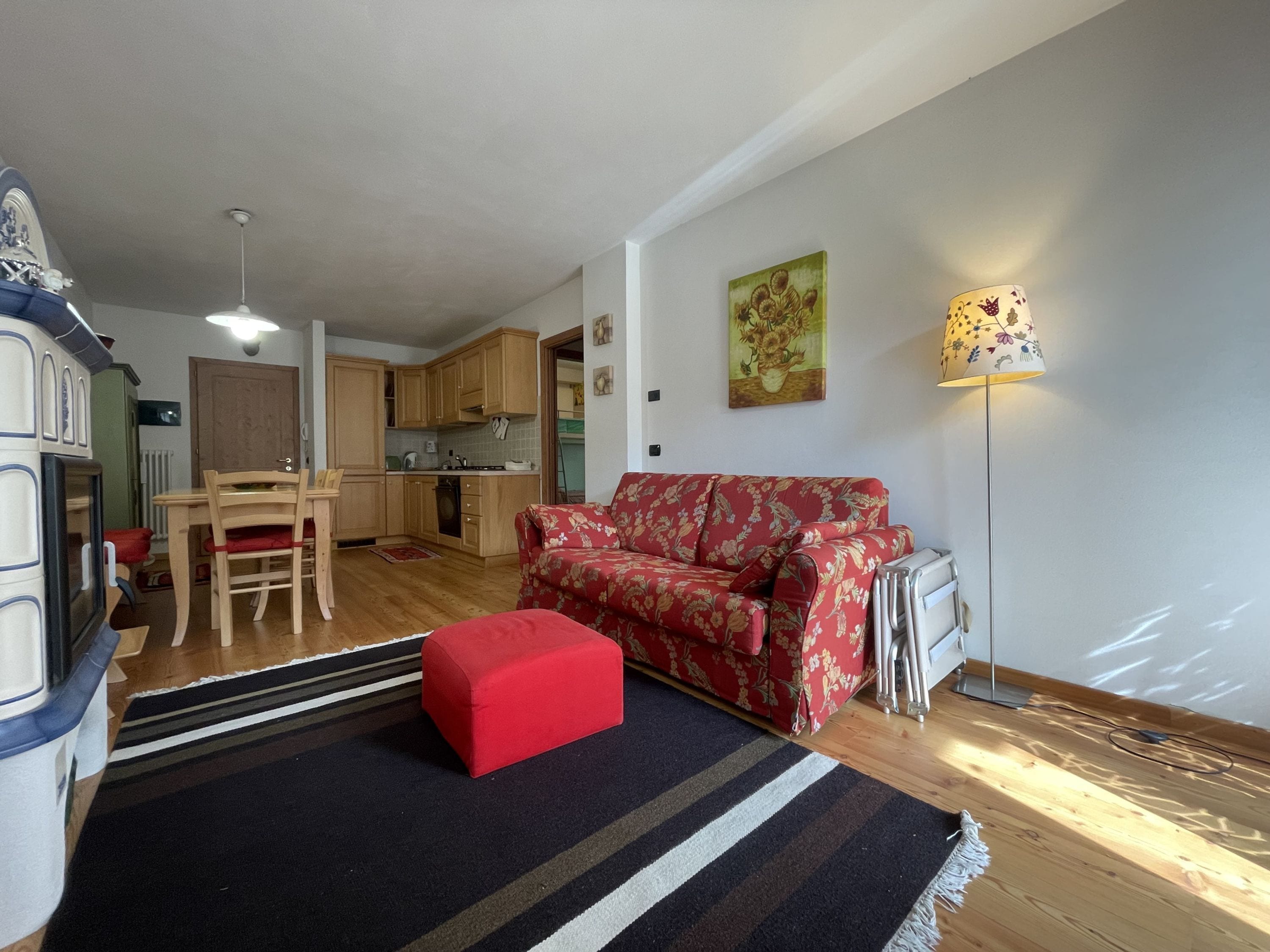 A compact living space with a kitchenette, a dining area, and a sofa.
