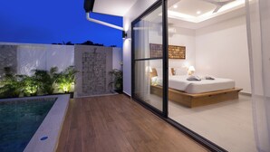 A modern bedroom with a glass wall, a wooden floor, and a built-in bed. - Two-Bedroom Villa with Salt Pool in Rawai (rawai)