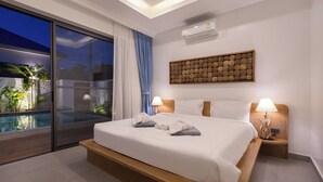 A modern hotel room with a large bed, a view of a swimming pool, and a ceiling with recessed lighting. - Two-Bedroom Villa with Salt Pool in Rawai (rawai)