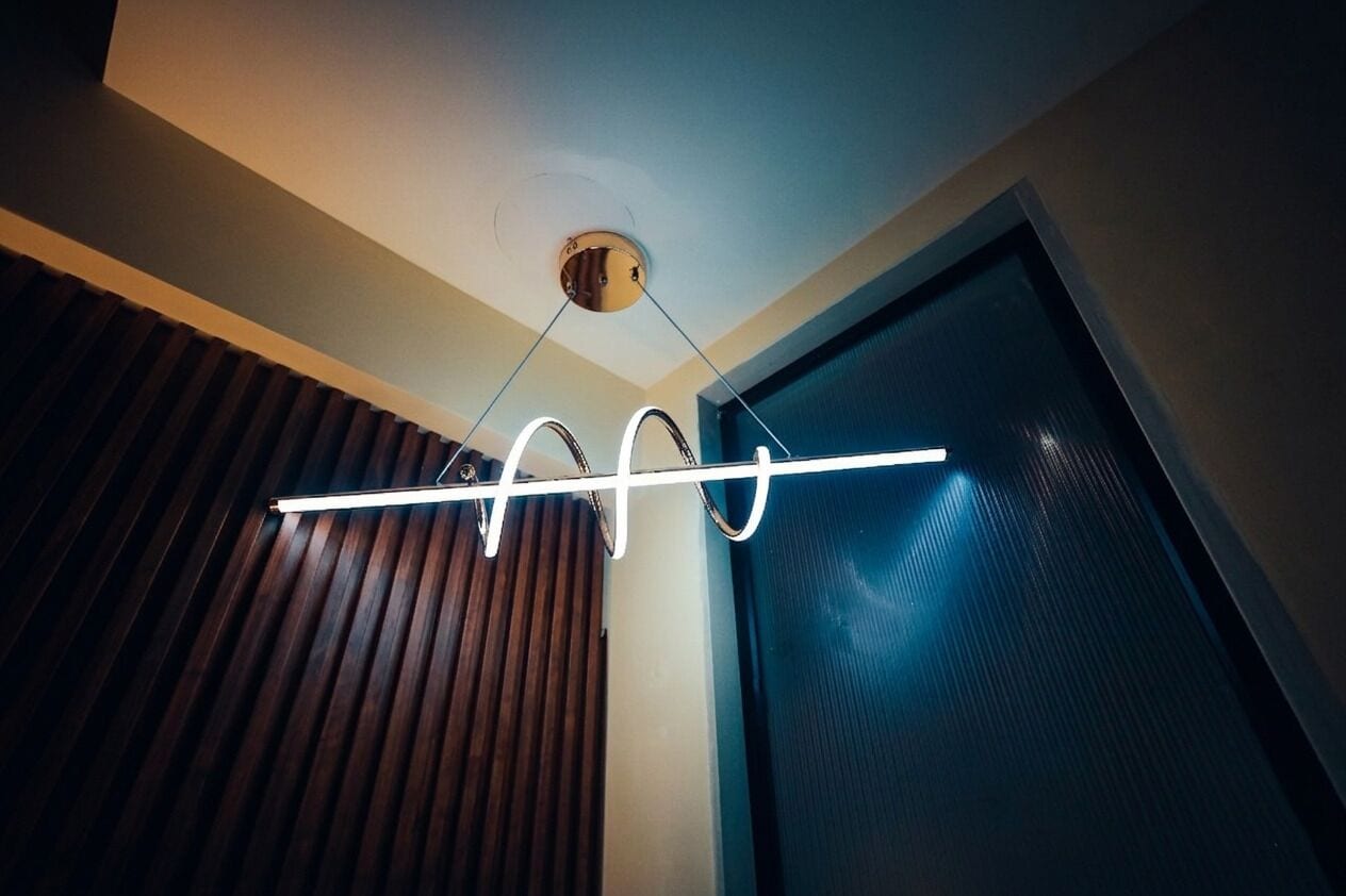 A modern ceiling light fixture with a linear design.