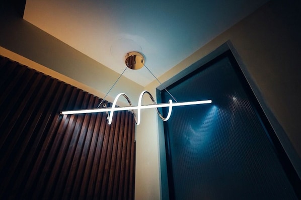 A modern ceiling light fixture with a linear design. - The Grand Sun City Hotel & Resort (Bhopal)