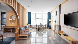 A modern hotel room with a wooden staircase, a dining area, a large flat-screen TV, and a large window with curtains. - ZEHAI HOTEL (Xi'an)