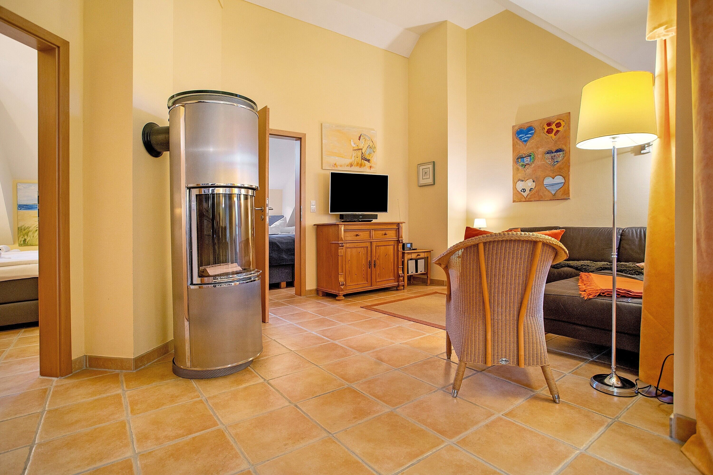 A living room with a sofa, a television, a cabinet, and a water dispenser.