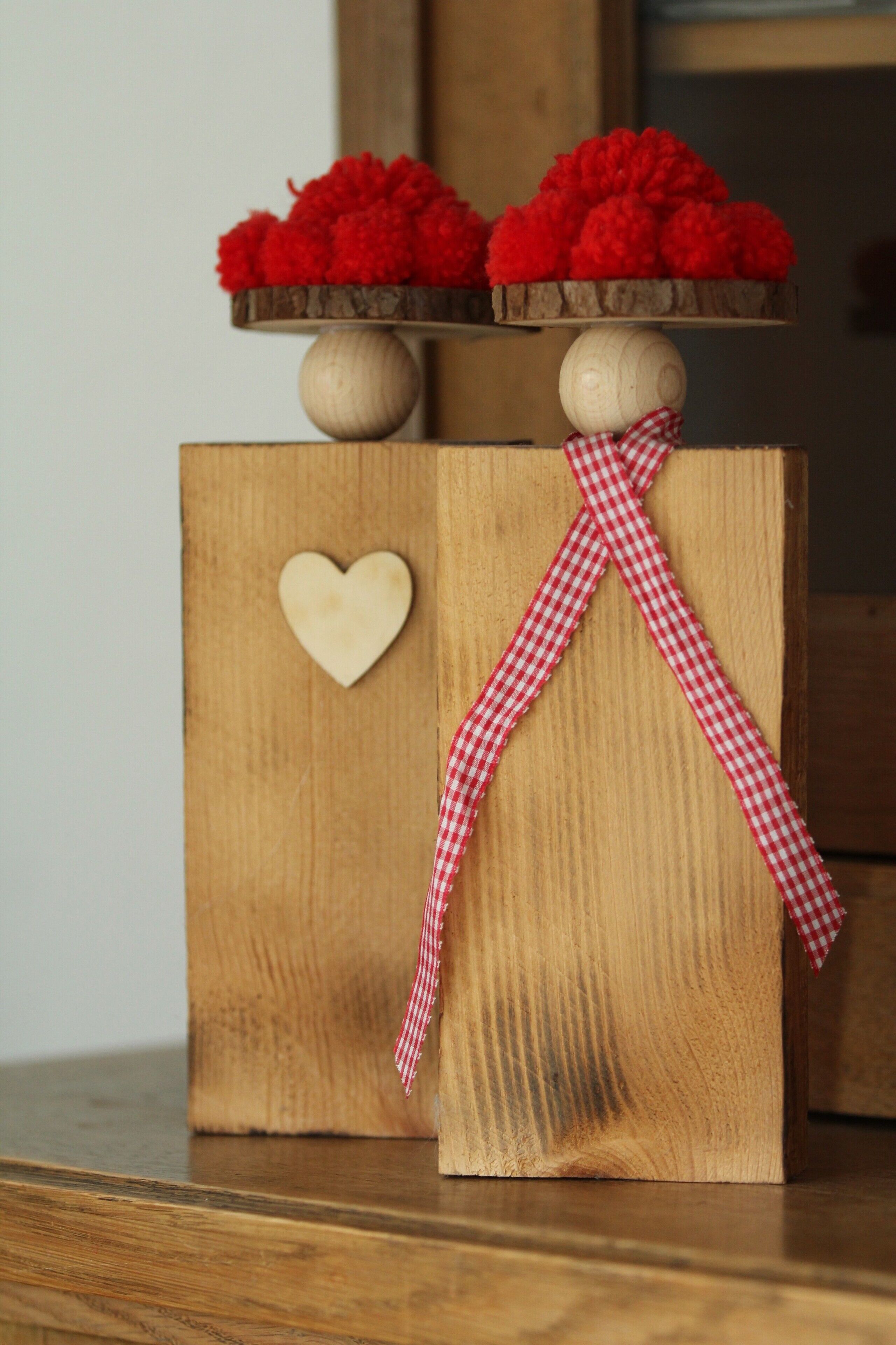 A wooden cabinet with a heart-shaped cutout and a checkered ribbon.