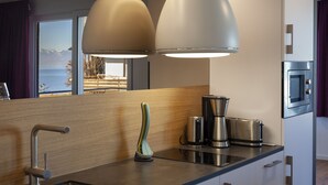 A modern kitchen with a built-in oven, a coffee maker, and a toaster. - Apartment 'South-West Lake View' – Exclusive Lake Constance Retreat (Immenstaad am Bodensee)