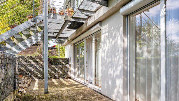 A modern building with a stone staircase, metal railings, and large glass doors. - Studio 'Jagst' with Shared Terrace and Wi-Fi (Michelbach an der Bilz)