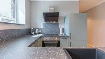 Een koelkast, een oven, een kookplaat, een vaatwasser