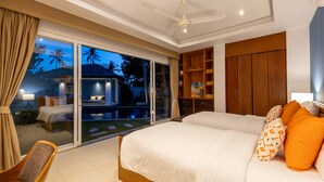 A bedroom with a large bed, a nightstand, a wooden wardrobe, and a sliding glass door leading to a pool area.