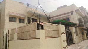 A two-story building with a balcony, a gated entrance, and a satellite dish. - V Food Dormitory (Jodhpur)