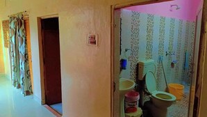 A bathroom with a toilet, bidet, and a bucket. - V Food Dormitory (Jodhpur)