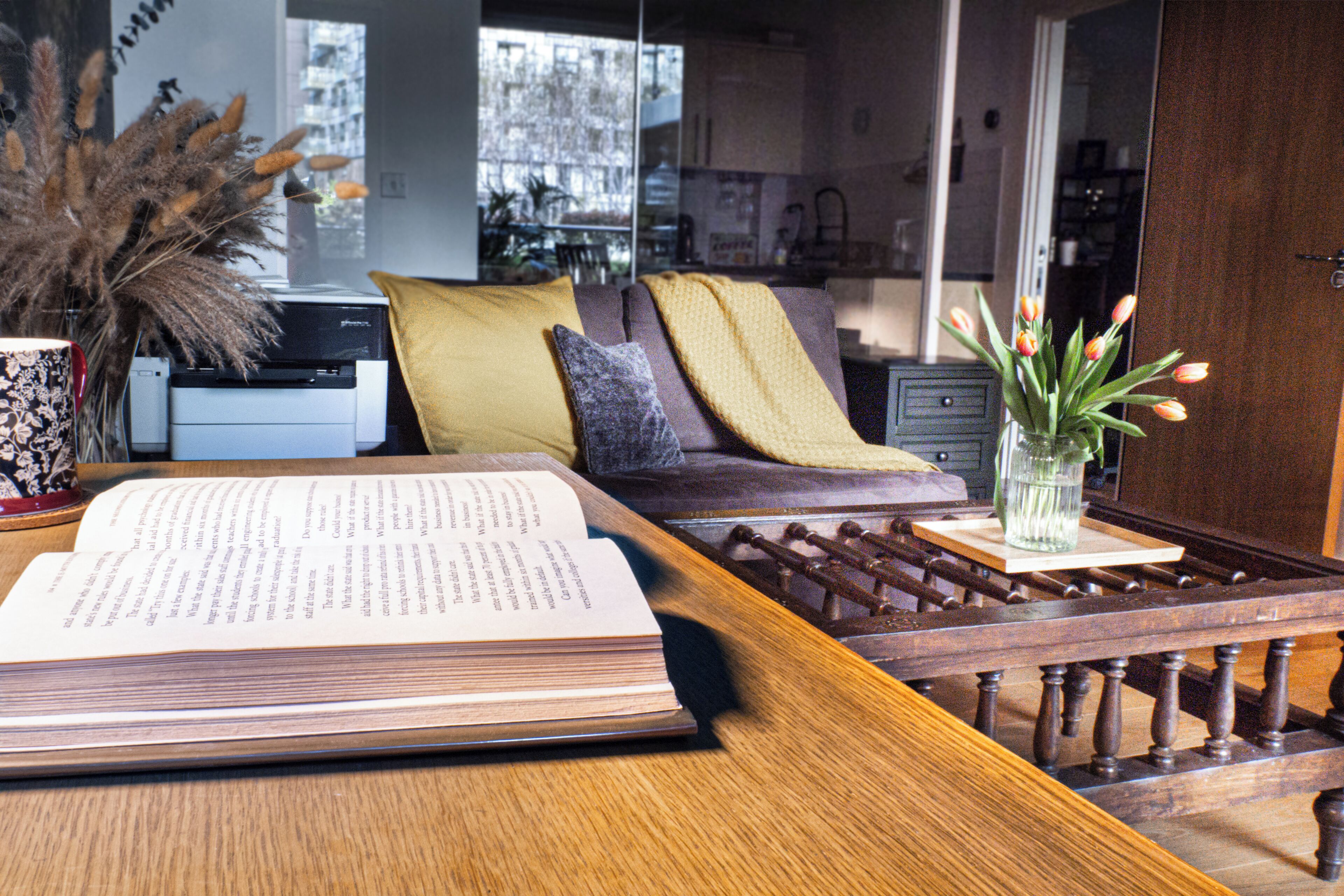 A reading area with a sofa, a coffee table, and a book.