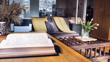 A reading area with a sofa, a coffee table, and a book.