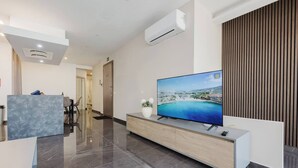 A modern hotel lobby with a large flat-screen TV, a reception desk, and a wooden panel wall. - Enjoy a stylish experience at this centrally-located place. Enjoy easy access to Qawra promenade only seconds away from parks and the aquarium.  Modern and stylish, this apartment in Qawra is the ideal place to spend a holiday. (San Pawl il-Baħar)