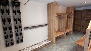 A modern bathroom with a shower, a wooden vanity, and a wall-mounted towel rack.