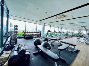 A gym with treadmills, dumbbells, and exercise balls. - Family Suite Colony By Infinitum KLCC  (Kuala Lumpur)