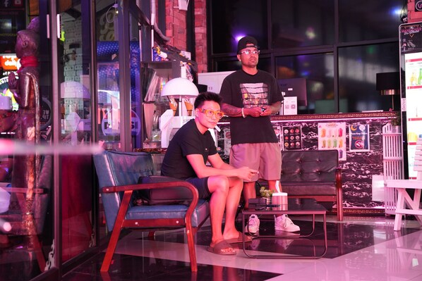A bar area with a sofa, a table, and a bar counter. - Hangover Hostel Patong (Patong)
