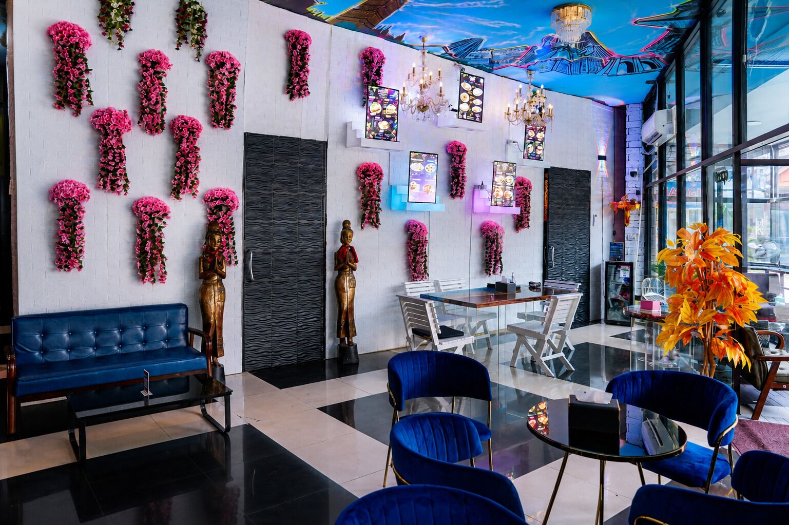 A modern interior with a blue sofa, a dining table, and chairs.