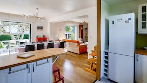 A modern kitchen with a wooden countertop, white cabinets, and a built-in refrigerator. - 600m from the beach, garden, house for 10 (Saint-Briac-sur-Mer)