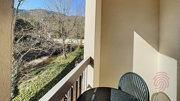 A balcony with a view of a dry landscape and trees.
