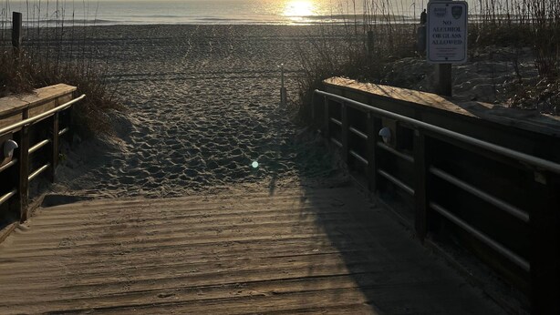 A wooden boardwalk leading to a beach with a sign prohibiting alcohol or glass. - 3 Blocks to Beach/Downtown & 2 Parking Spots, 3 BLOCKS FROM THE BEACH & BOULEVARD -Lindy's Landing (Carolina Beach)