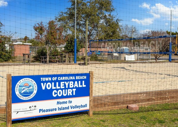 Un terrain de volleyball avec un panneau indiquant qu’il fait partie de la ville de Carolina Beach.