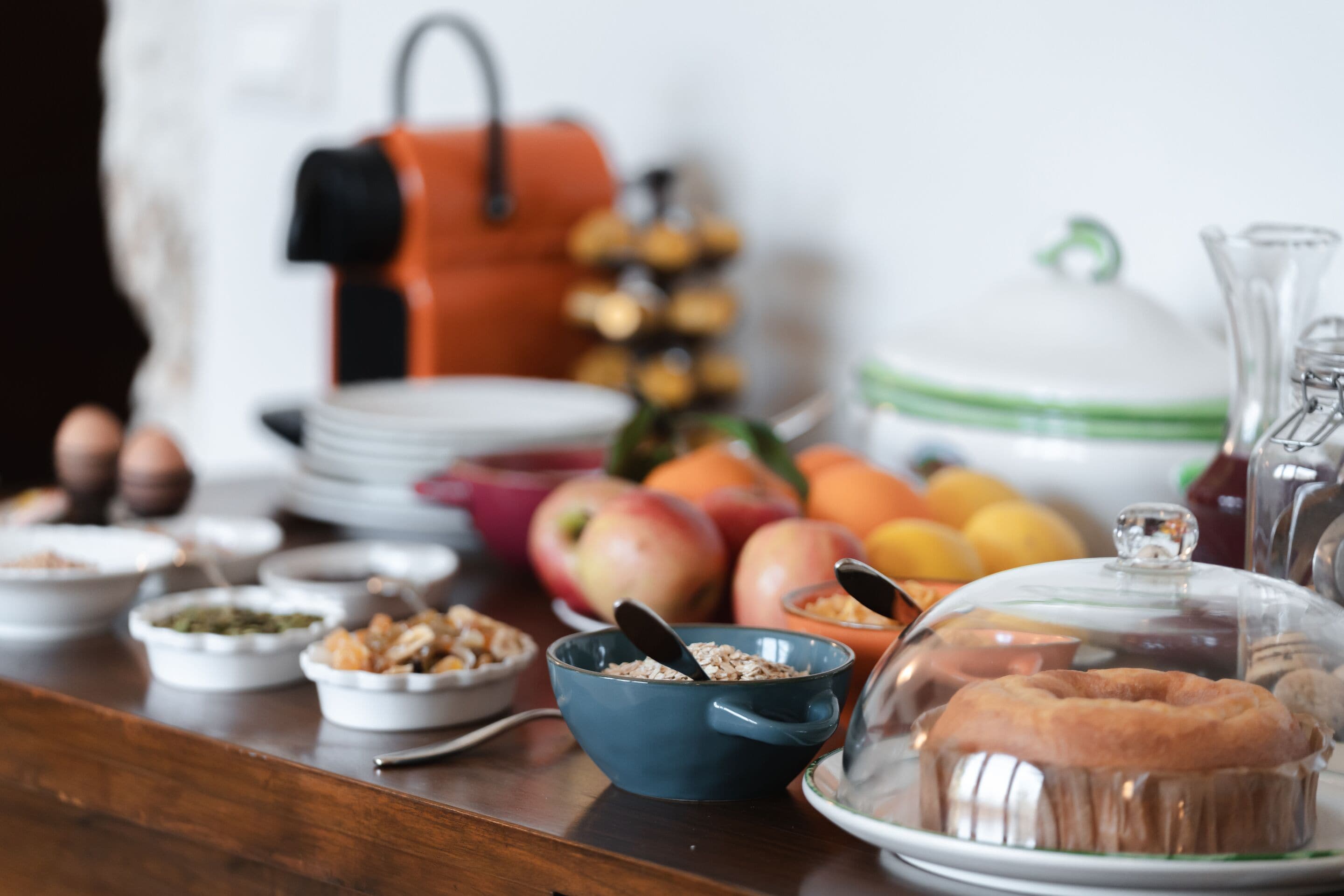 A breakfast buffet with various food items and a coffee station.