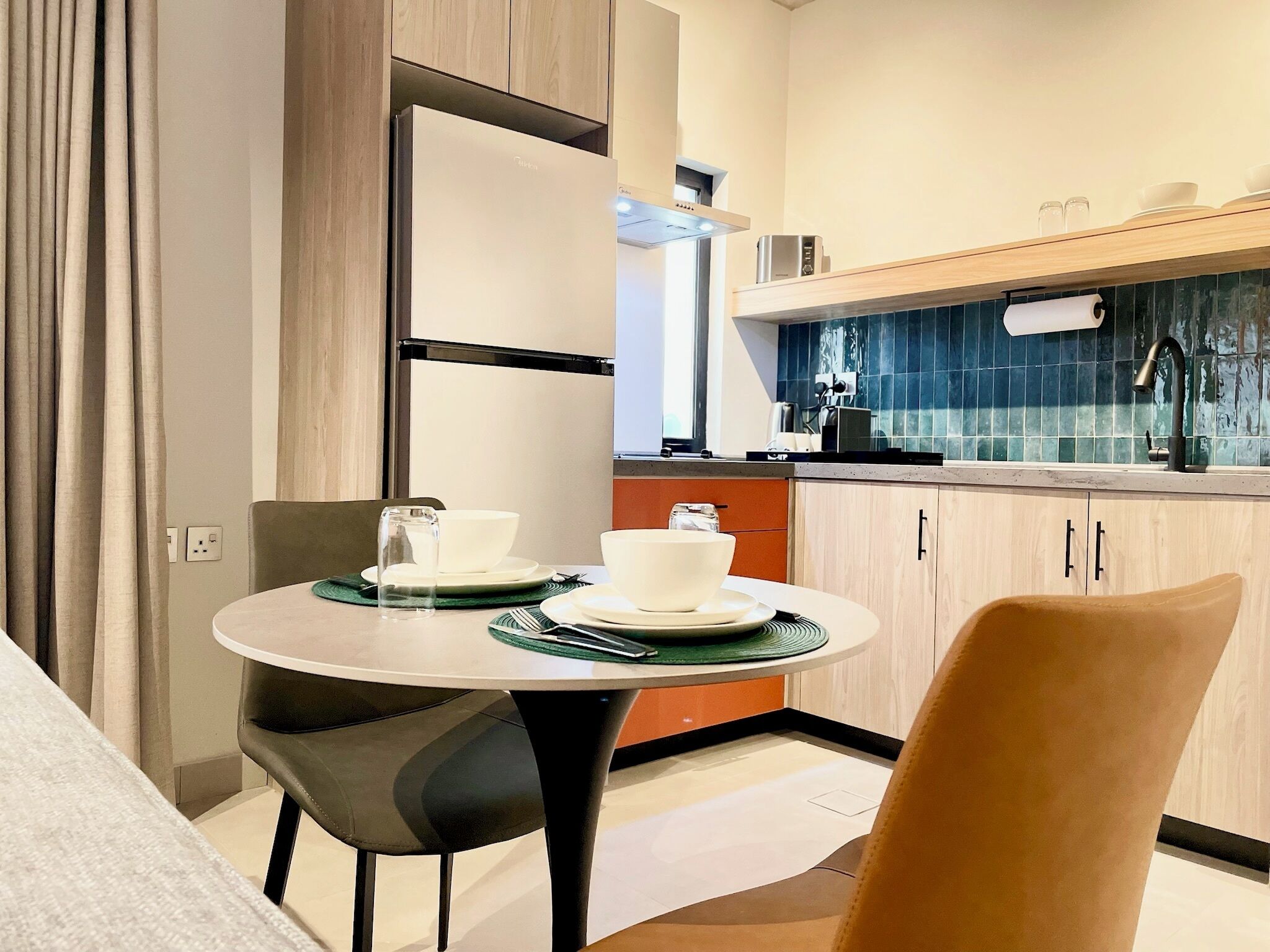 A modern kitchen with a dining area.