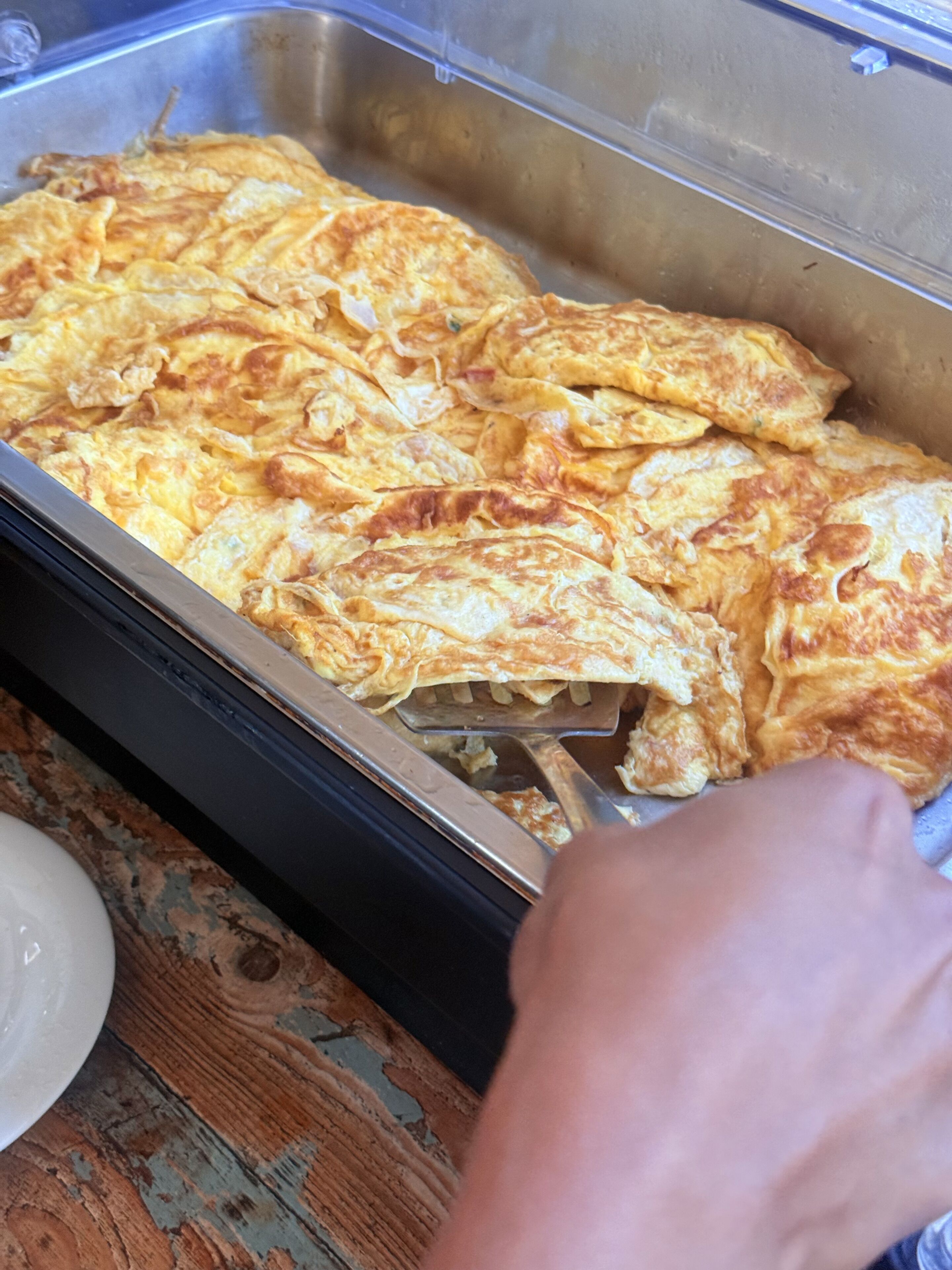 A tray of omelettes in a metal container.