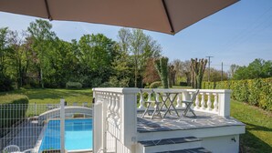 A swimming pool with a stone deck, a white fence, and a covered area with steps leading to a white railing. - Spacious family home in Brizay, Near Chinon and Azay-le-Rideau (Up to 15 Guests) (Brizay)