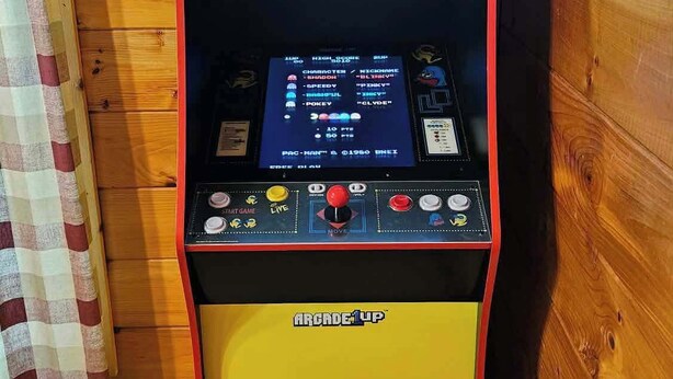 A Pac-Man arcade machine with a yellow base and red accents. - Spacious cabin, Pigeon Forge-GSMNP-Relaxing & fun (Sevierville)