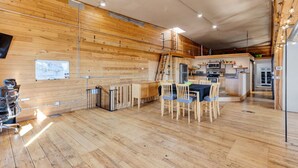 A wooden interior with a dining area, kitchen, and a staircase. - The Bitterroot Loft On 1st Street (Hamilton)