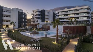 Et moderne hotelkompleks med flere bygninger, en swimmingpool og udendørs siddeområder.