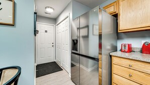 A modern kitchen with stainless steel appliances, wooden cabinets, and a granite countertop. - Near Speedway & Shops: Concord Apt w/ Shared Yard! (Concord)