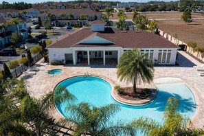 A residential area with a swimming pool, a covered patio, and a view of neighboring houses. - Spacious 4Bd Disney Dream With Resort Access at Lucaya 3210 (Kissimmee)