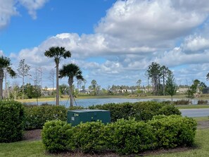 Surrounded by lush greenery and palm trees, this serene landscape offers a peaceful escape.