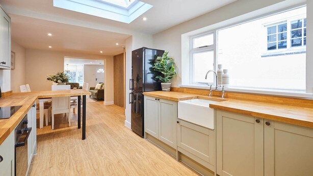 A modern kitchen with a skylight, wooden countertops, and a built-in sink. - Host & Stay | Ginger Bread Cottage (Stokesley)