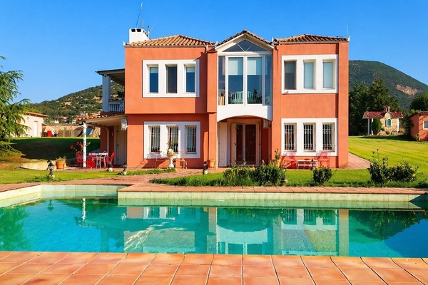 Elegant Villa Facade with Private Pool and Lush Garden Views