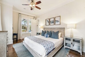 A bedroom with a bed, a ceiling fan, a nightstand, a lamp, and framed pictures on the wall. - Private Pool & Spa Retreat w/ LSV in WaterColor’s Forest District (Santa Rosa Beach)