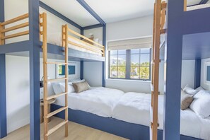 A bunk bed room with a ladder, a window with a view, and a bedside table. - The Starboard House at Solaire Lunara Bay (Key West)