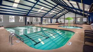 An indoor swimming pool with clear water, a blue ceiling, and a green canopy over one section. - Magnolia Pointe Luster Leaf 4887-201 3 Bedroom Condo (Myrtle Beach)